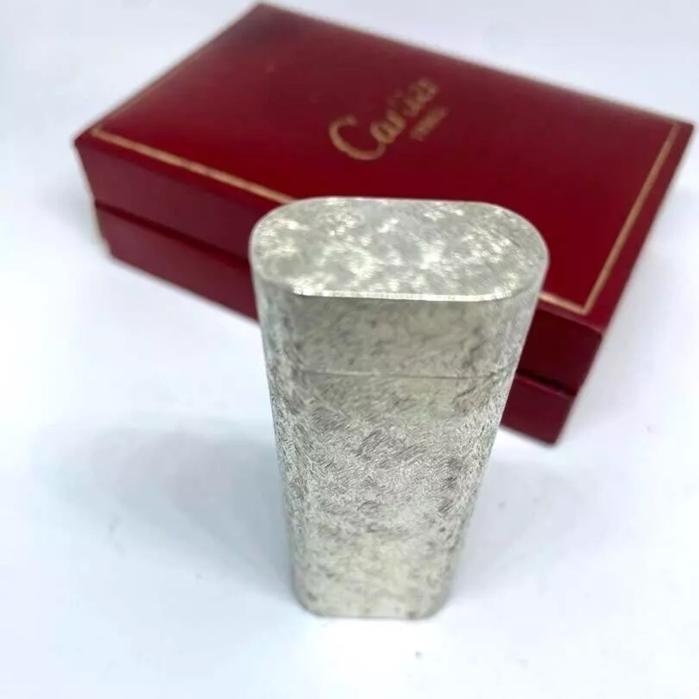 Cartier Silver leaf authentic lighter with code on bottom. Case sold .